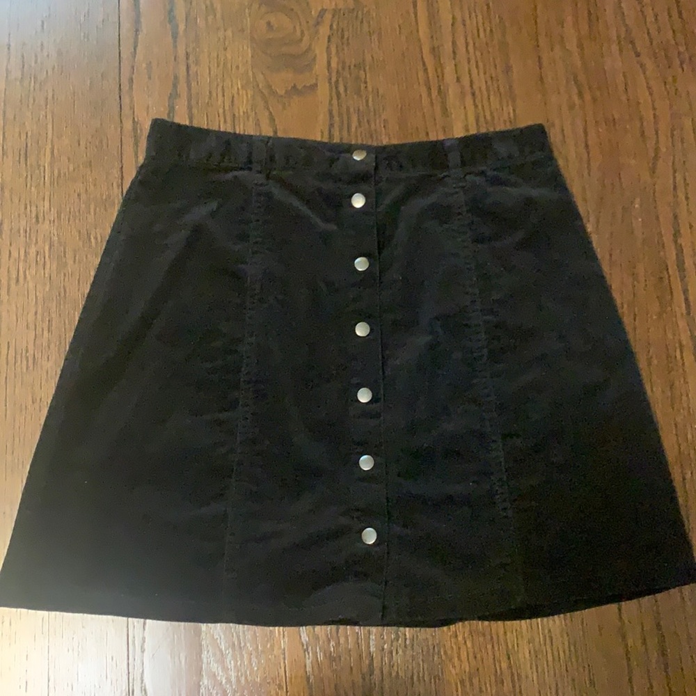 Black corduroy mini skirt with button detail